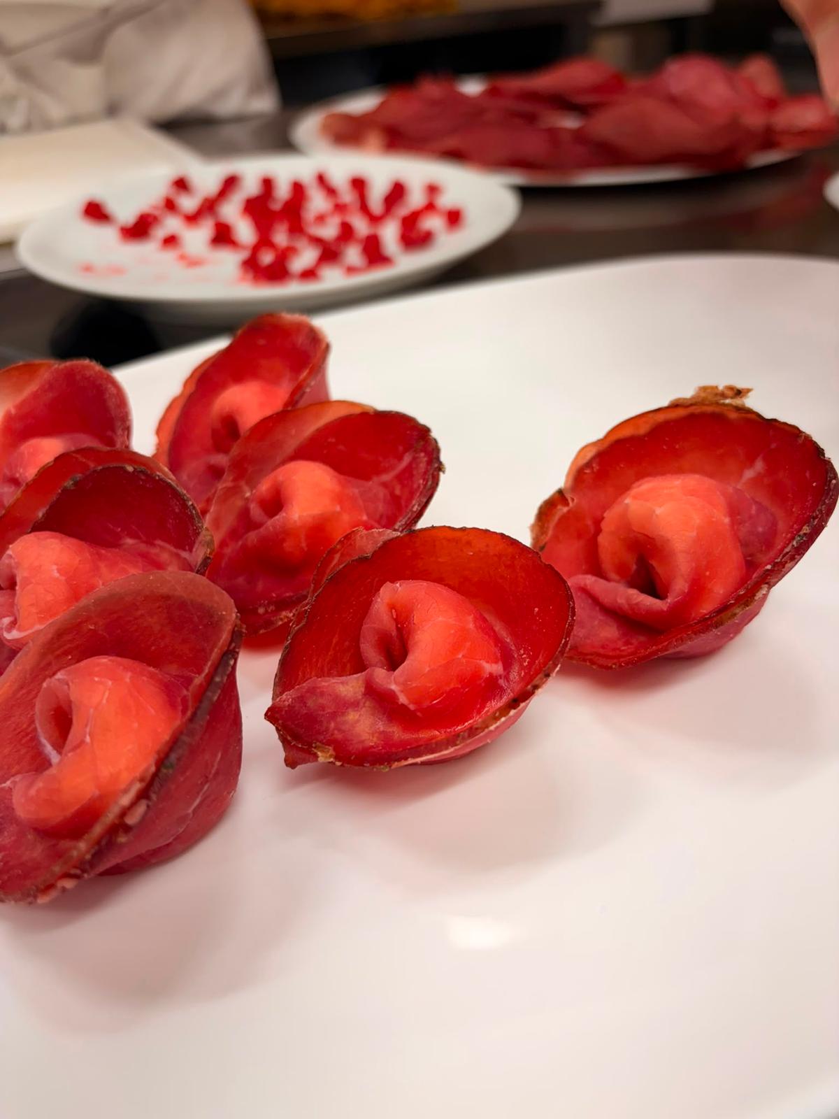 Piatto di carne fumada con purea e lamponi
